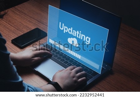 Woman updating software on laptop. System engineer and programming. Software apps developer.  Royalty-Free Stock Photo #2232952441