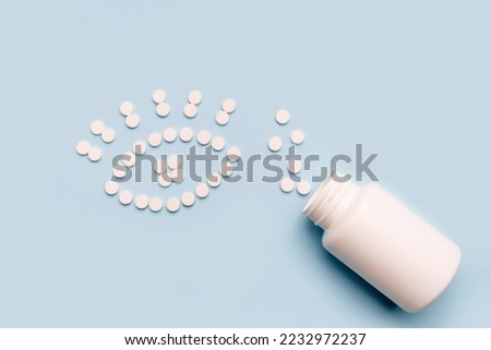 Ophthalmology healthcare concept. The eye is made of pills, Treatment or prevention of eye diseases with tablets. Pills spilled from a white bottle 
