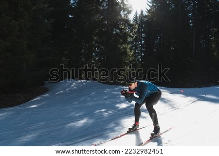 Nordic skiing or Cross-country skiing classic technique practiced by man in a beautiful panoramic trail at morning. Royalty-Free Stock Photo #2232982451