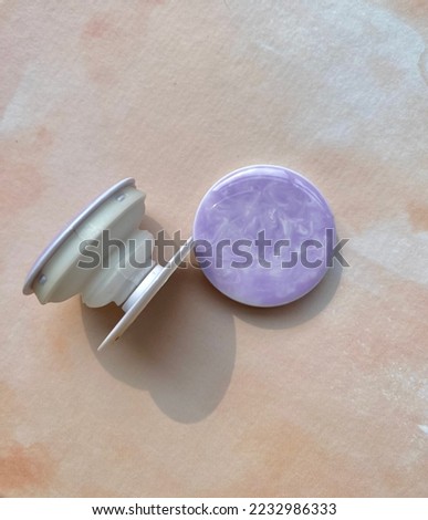 phone grip with purple and white colors Royalty-Free Stock Photo #2232986333