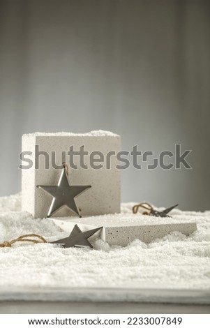 Winter photo of pedestal and decoration of snow flakes. Free space for your decoration. 