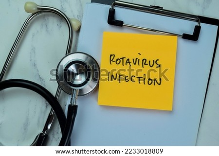 Concept of Rotavirus Infection write on sticky notes with stethoscope isolated on Wooden Table. Royalty-Free Stock Photo #2233018809