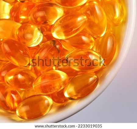 fish oil capsules in the small ceramic bowl