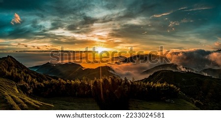 Panorama of the sunrise in the mountains. Sunrise fog in the morning in mountains. Mountain valley sunrise. Beautiful sunrise in foggy mountains Royalty-Free Stock Photo #2233024581
