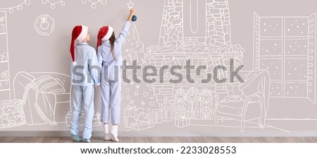 Little children in Santa hats and pajamas decorating Christmas tree in drawn living room