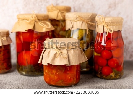 Preservation of vegetables in jars. fermentation products. Harvesting tomatoes and cucumbers, mushrooms, salads for the winter. Jars with pickled vegetables. marinated food. Stocks for the winter. 