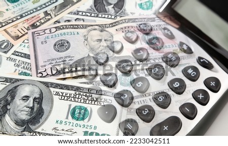 Calculator and American banknotes composite
