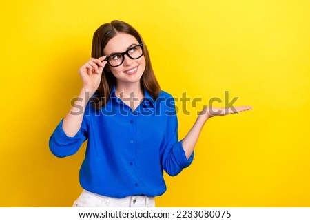 Photo of cute young lady business company owner hold palm touch glasses look minded empty space advertising isolated on yellow color background Royalty-Free Stock Photo #2233080075