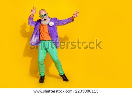 Full size photo of nice grandpa have fun nightclub superstar dance floor wear trendy colorful look isolated on yellow color background