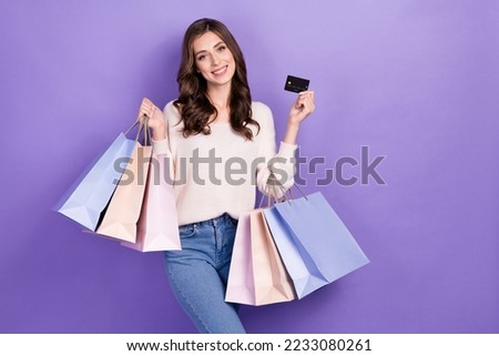 Photo of positive lady fashionista show recommend bank card easy functions fast purchases empty space isolated on purple color background