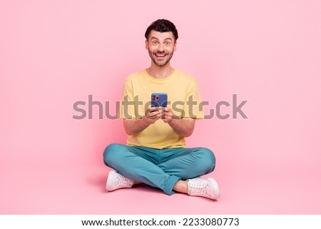 Photo of cheerful man satisfied using modern quality device gadget low price sale shopping isolated on pink color background