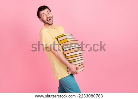 Photo of cheerful man wear trendy clothes carry books like reading literature preparing exam empty space isolated on pink color background