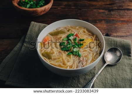 White Bowl of Duck Noodle Soup with Vegetables