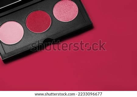 Palette of colorful eyeshadows from high view. New 2023 trending PANTONE 18-1750 Viva Magenta color
