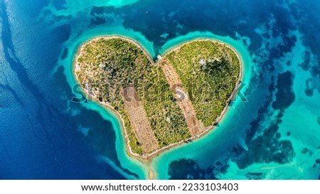 Aerial view of the heart shaped Galesnjak island on the adriatic coast, Zadar, Croatia. Heart shaped island of Galesnjak in Zadar archipelago aerial view, Dalmatia region of Croatia. Royalty-Free Stock Photo #2233103403