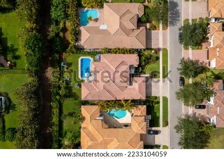 Aerial drone view to the suburbs in Delray Beach in Miami Florida, there is large tropical vegetation, houses with tiles  Royalty-Free Stock Photo #2233104059
