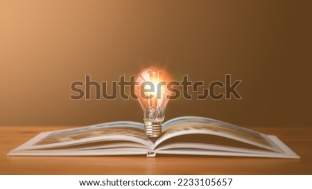 light bulb glowing on book, idea of ​​inspiration from reading, innovation idea concept, Self learning or education knowledge and business studying concept.