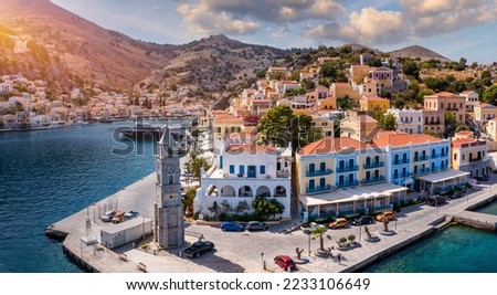 Aerial view of the beautiful greek island of Symi (Simi) with colourful houses and small boats. Greece, Symi island, view of the town of Symi (near Rhodes), Dodecanese. Royalty-Free Stock Photo #2233106649