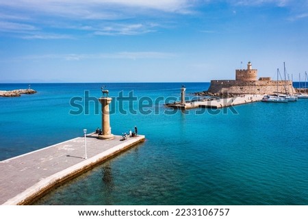 Mandraki port with deers statue, where The Colossus was standing and fort of St. Nicholas. Rhodes, Greece. Hirschkuh statue in the place of the Colossus of Rhodes, Rhodes, Greece Royalty-Free Stock Photo #2233106757
