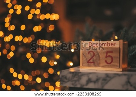 Merry christmas day 25 december eve event fairytale vibes. Sparkling bokeh garland shiny glister twinkle lights Noel tree decorations wooden cube calendar festive candles winter holidays spirit Xmas