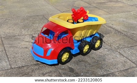 Plastic car and toys in the garden