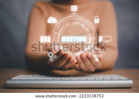 Web hosting concept, Woman hand holding on the virtual screen inscription Hosting on desk, Internet, business, Technology and network concept.