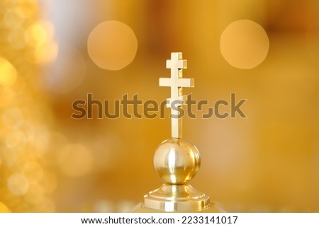 Gold Greek Orthodox cross close-up. Orthodox christian religious traditions. Royalty-Free Stock Photo #2233141017