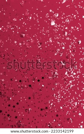 Christmas festive banner background: confetti with sparkling glitter and stars. New 2023 trending PANTONE 18-1750 Viva Magenta color