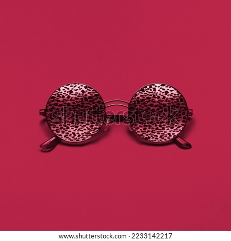 Beautiful trendly sunglasses with leopard pattern on a New 2023 trending PANTONE 18-1750 Viva Magenta color