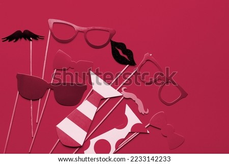 Photo booth props glasses, mustache, lips on a pink background flat lay. New 2023 trending PANTONE 18-1750 Viva Magenta color