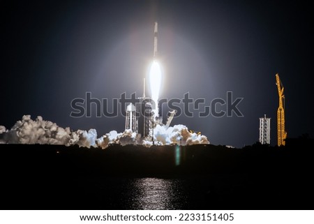 SpaceX rocket Falcon 9 rocket  capsule soars upward after lifting off from launch pad. Digitally enhanced. Elements of this image furnished by NASA. Royalty-Free Stock Photo #2233151405