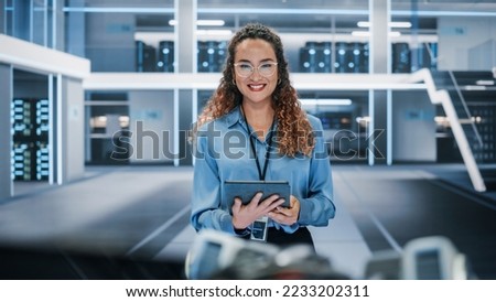 Portrait of a Beautiful Latin Female Wearing Smart Corporate Shirt and Glasses, Looking at Camera and Smiling. Businesswoman, Information Technology Manager, Robotics Engineering Specialist. Royalty-Free Stock Photo #2233202311