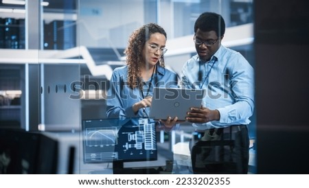 Multiethnic Robotics Engineer Talking to Project Manager, Discussing Robot Dog Concept in High Tech Research and Development Facility. Professional Industrial Scientists Working in the Background. Royalty-Free Stock Photo #2233202355