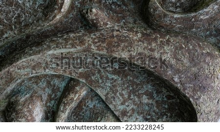 Close up concrete molded sculpture with black markings background and wallpaper texture