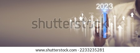 Businessman analyzes performance profitability of working companies with digital augmented reality graphics, positive indicators in 2023, businessman calculates financial data for investment Royalty-Free Stock Photo #2233235281