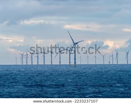 Offshore and Onshore Windmill farm Westermeerwind, Windmill park in the Netherlands with huge large wind turbines, group of windmills for renewable electric energy Royalty-Free Stock Photo #2233237107