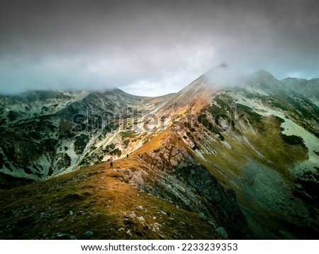 Mountain adventurers go to the top of Papusa Peak. Royalty-Free Stock Photo #2233239353
