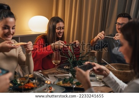 Friends take pictures of a nice meal