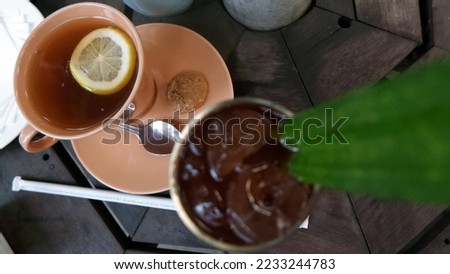 Lemon tea and Lemon iced tea with pandan leaves - Stock Photo
