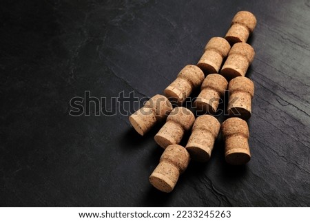 Christmas tree made of wine corks on dark stone background. Space for text