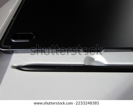          black digital tablet and stylus                      