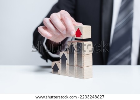 Wooden blocks with black and red arrows icons, business profit growth success concept
