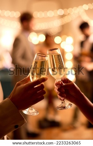 Close Up Of Couple At Party Making Champagne Toast Together Royalty-Free Stock Photo #2233263065