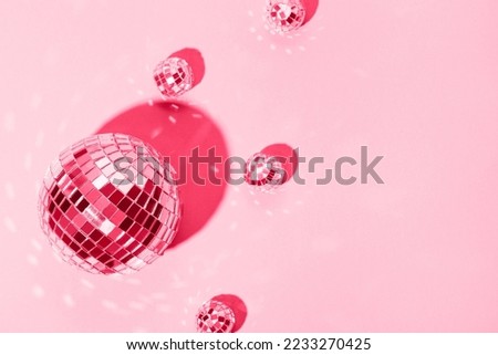  Beautiful disco balls on a pink background. Modern postcard with space for text. Image toned in the color of the year 2023 Royalty-Free Stock Photo #2233270425