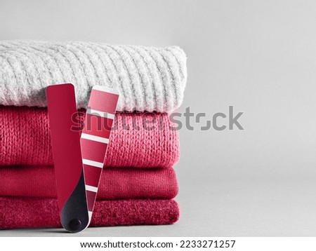 Stack of sweaters and color fun palette in classic blue 2020 color. Color of year 2020 concept for fashion and clothing industry. Copy space Royalty-Free Stock Photo #2233271257