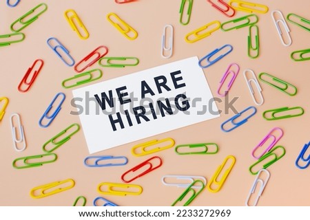 Text - We are hiring, written on paper. Employee vacancy announcement. Business recruiting, Hiring Business concept Royalty-Free Stock Photo #2233272969