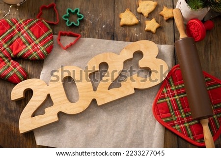 NEW year merry Christmas and happy holiday Christmas cookies wooden numbers 2023 on a dark wooden background eco-friendly general plan place for text. High quality photo