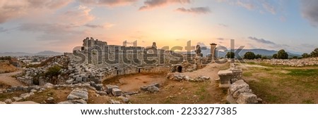 Xanthos Ancient City. Grave monument and the ruins of ancient city of Xanthos - Letoon in Kas, Antalya, Turkey at sunset. Capital of Lycia. Royalty-Free Stock Photo #2233277385