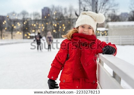 cute funny happy kid on winter skating rink in frost looking at camera close up with space for text Royalty-Free Stock Photo #2233278213