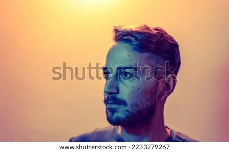 led colors photo portrait with copy space of proud caucasian young man looking away